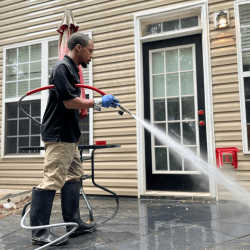 Mighty Pro Wash technician cleaning patio surface - Metro Atlanta GA
